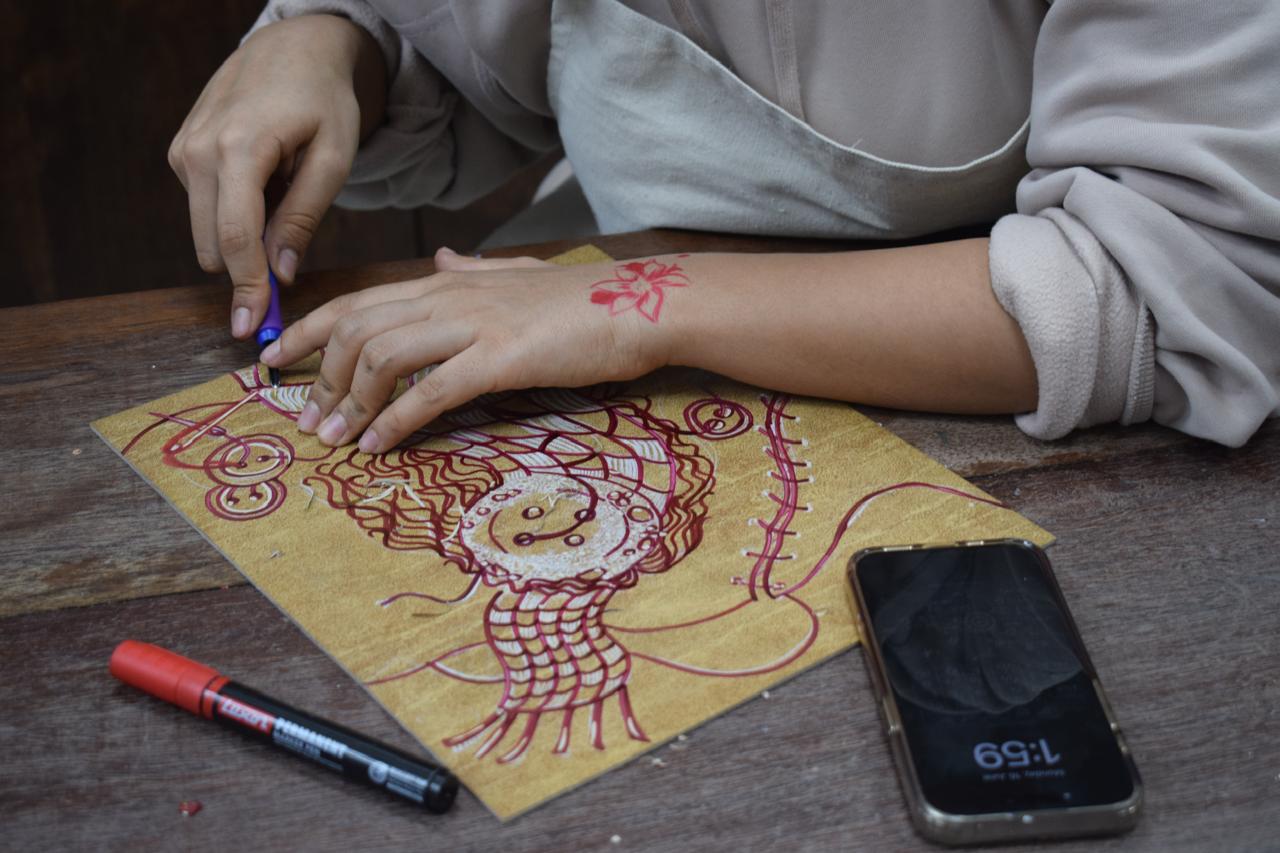 Student working on linocut printmaking